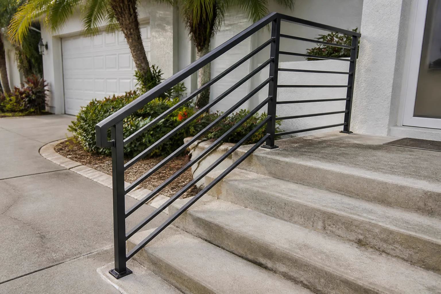 Custom black steel handrail on concrete steps